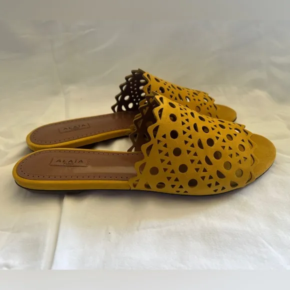 Alaïa Leather slip ons laser cut vienne cut outs. NWT. Mustard color.