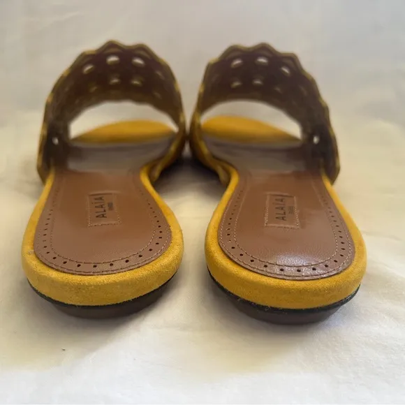Alaïa Leather slip ons laser cut vienne cut outs. NWT. Mustard color.
