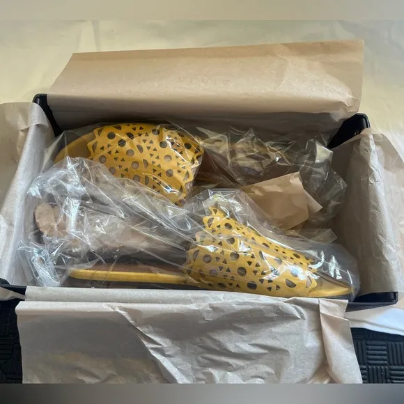 Alaïa Leather slip ons laser cut vienne cut outs. NWT. Mustard color.
