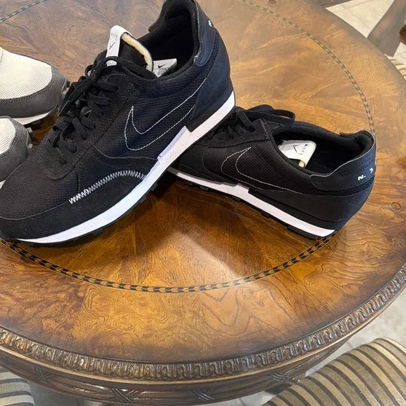 Two pair of brand new Nike means size 10 shoes