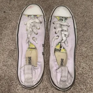 Well worn and well loved womens light purple converse shoes